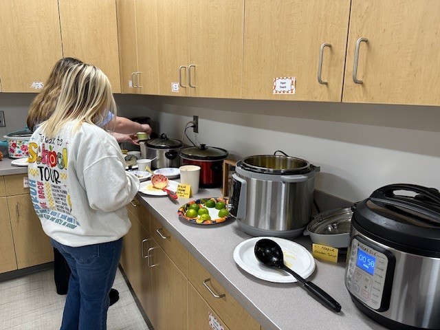 Teachers getting food for our Thanksgiving lunch.