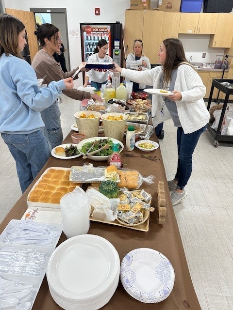 Teachers getting food for our Thanksgiving lunch.
