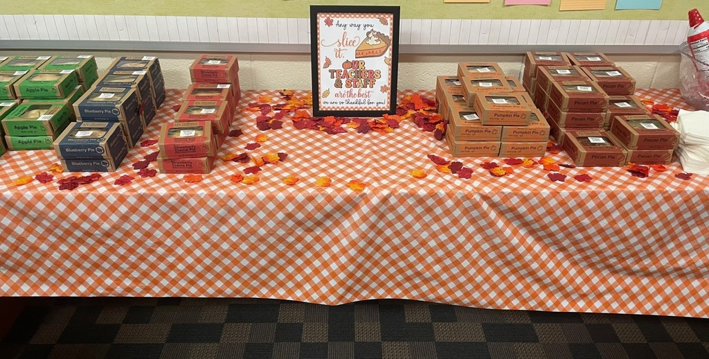 a festive fall themed table with stacks of mini pies