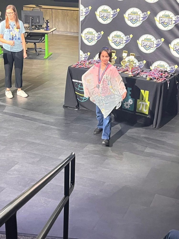 a girl wearing a cape or poncho 