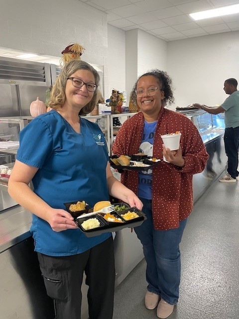 Melissa smiling with a mom for our thanksgiving lunch. 
