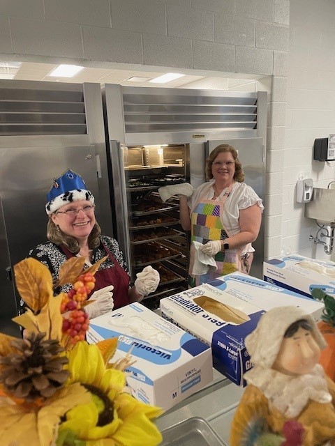 Staff helping serve thanksgiving lunch.