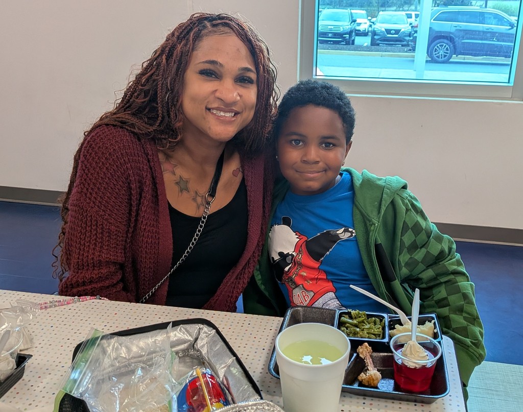 Mom and son smiling for a picture. 