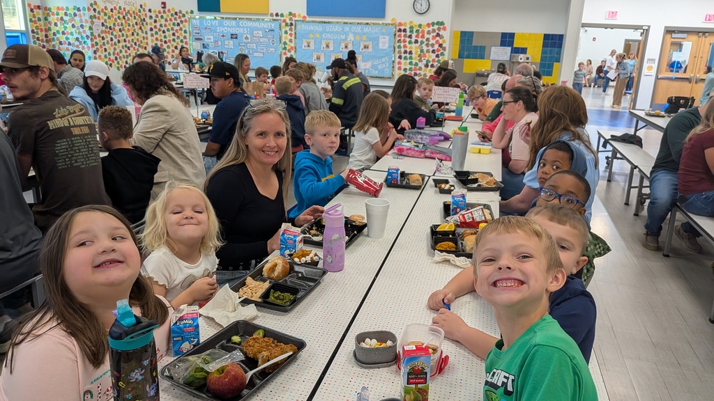 Classroom of students smiling for a picture during our thanksgiving lunch.