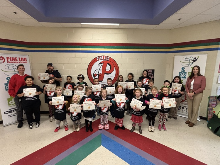 a group of students and staff members holding certificates they won