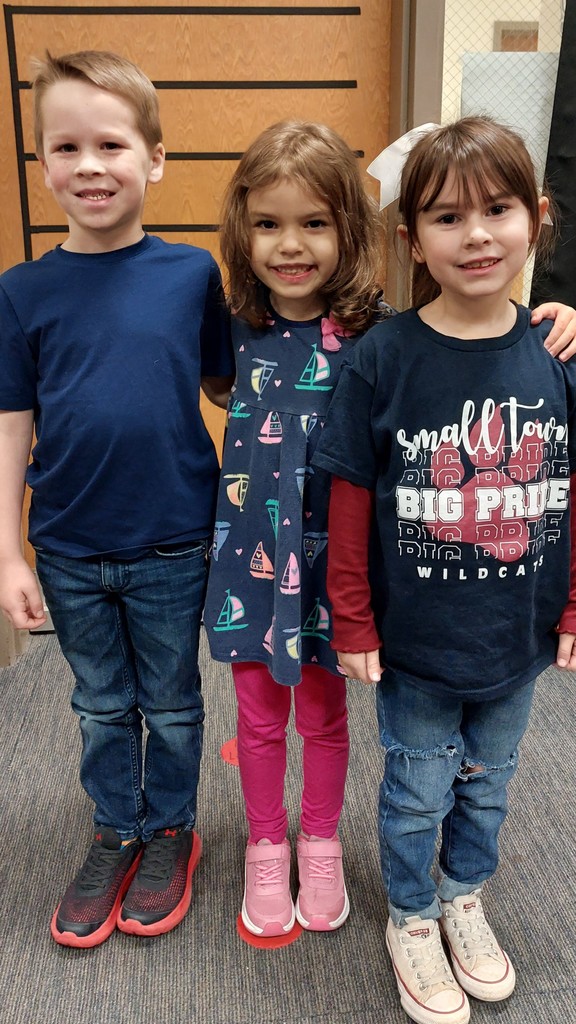 two girls and a boy in navy shirts