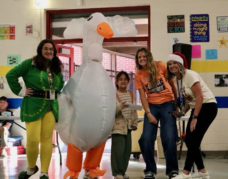 Gertie the Attendance Goose giving Mule House gift card to Julia (K-2 winner) & Joel (3-5 winner) for having perfect attendance. 
