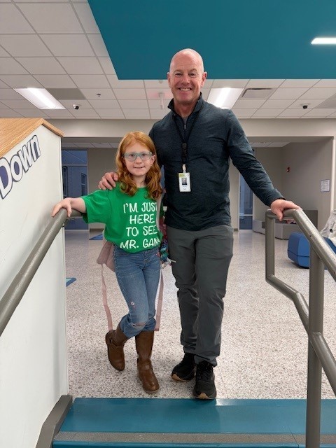 Our music teacher smiling in a picture with a student. 