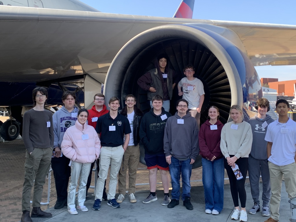 group of CTAE standing by Delta plane in Atlanta