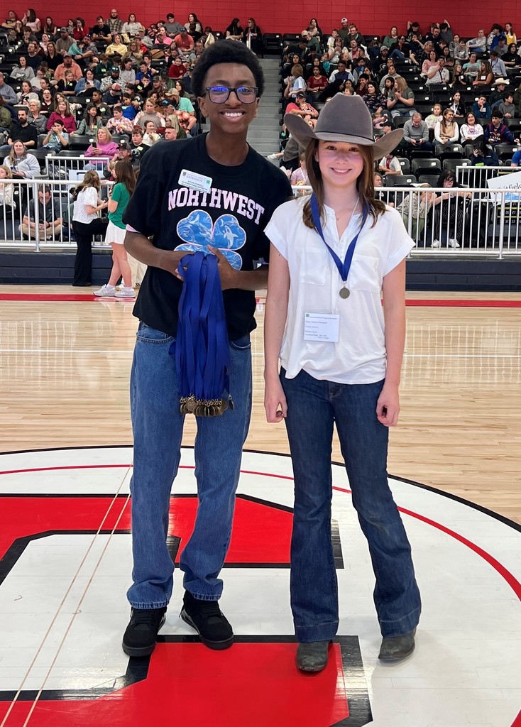 5th grade student smiling for a picture after winning a medal at the 4H competition. 