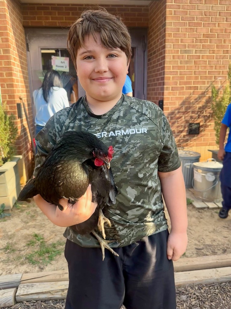 Waylon, a student at KES, holding a chicken