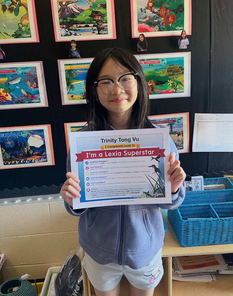 Trinity holding a certificate that says "I'm a Lexia Superstar"