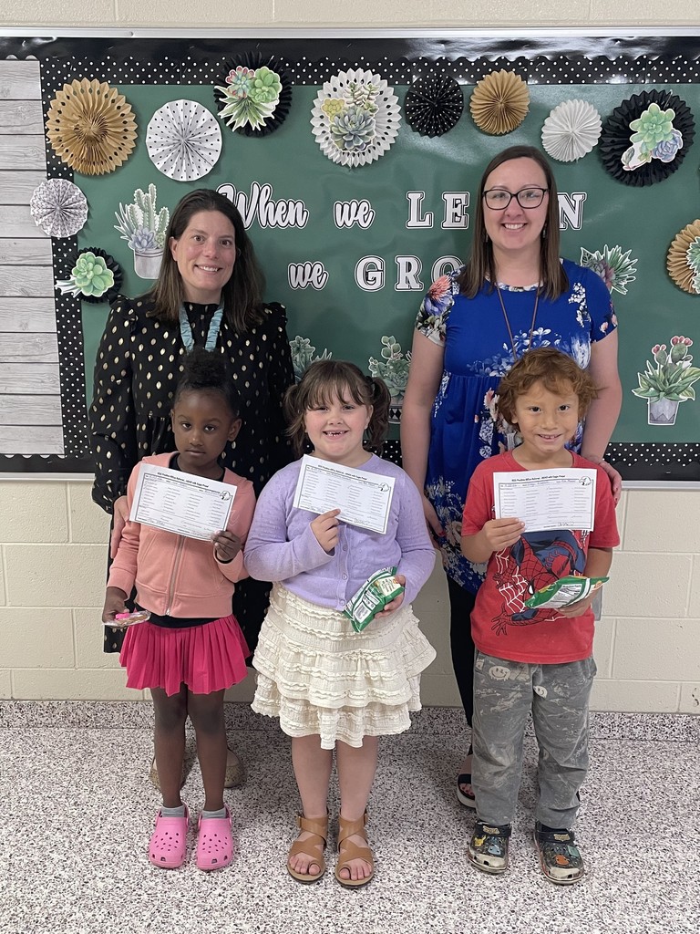 Dr. Payne and Mrs. Larue stand with students holding certificates.