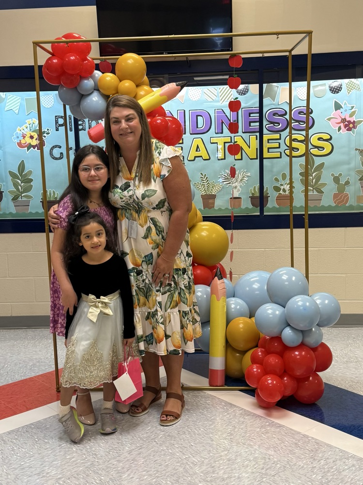 Mrs. Bennett with two girls at open house