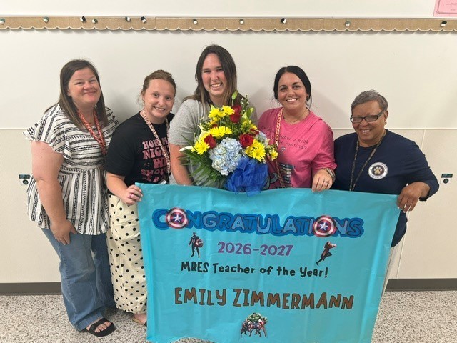 Ms. Zimmerman with her grade level team smiling for a picture. 