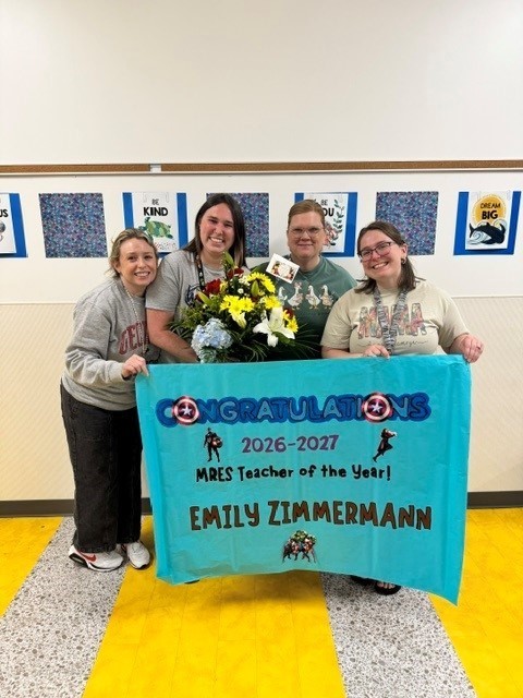 Ms. Zimmerman with our academic coaches smiling for a picture.