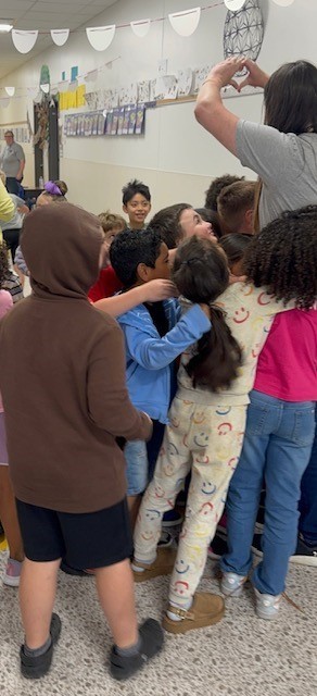 Students hugging and congratulating Ms. Zimmerman our teacher of the year.