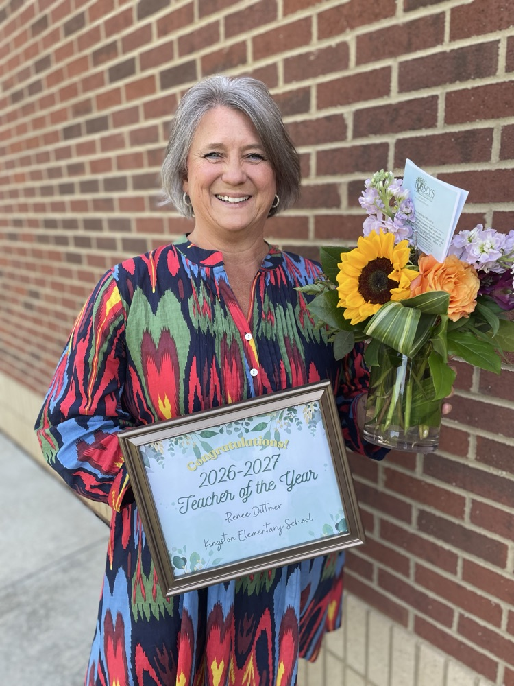 Mrs. Dittmer with a certificate and flowers