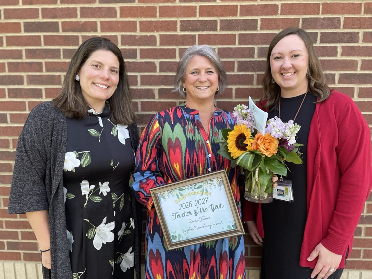 Dr. Payne, Mrs. Dittmer, and Mrs. LaRue pose with her certificate and flowers  