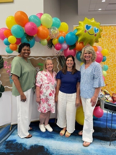 Our four teachers that are retiring this year smiling for a picture at our retirement party. 