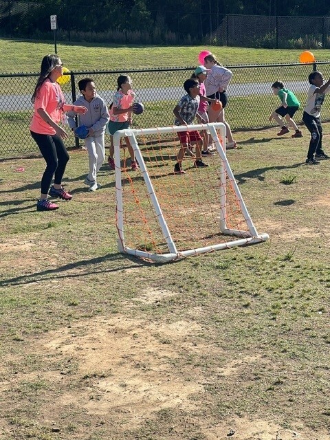 Students playing dodgeball during field day.