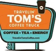 A sign displays "Travelin' Tom's Coffee Truck" in bold white letters on orange and blue background. The logo features a coffee cup with steam on top.