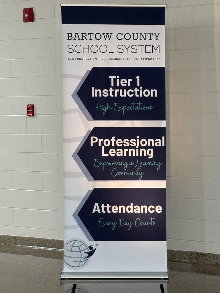 Banner with "Bartow County School System" and "Tier 1 Instruction" displayed against a white brick wall.