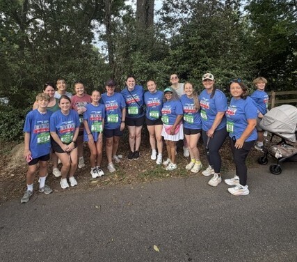Group picture of MRES staff smiling for a picture before the 5K race.