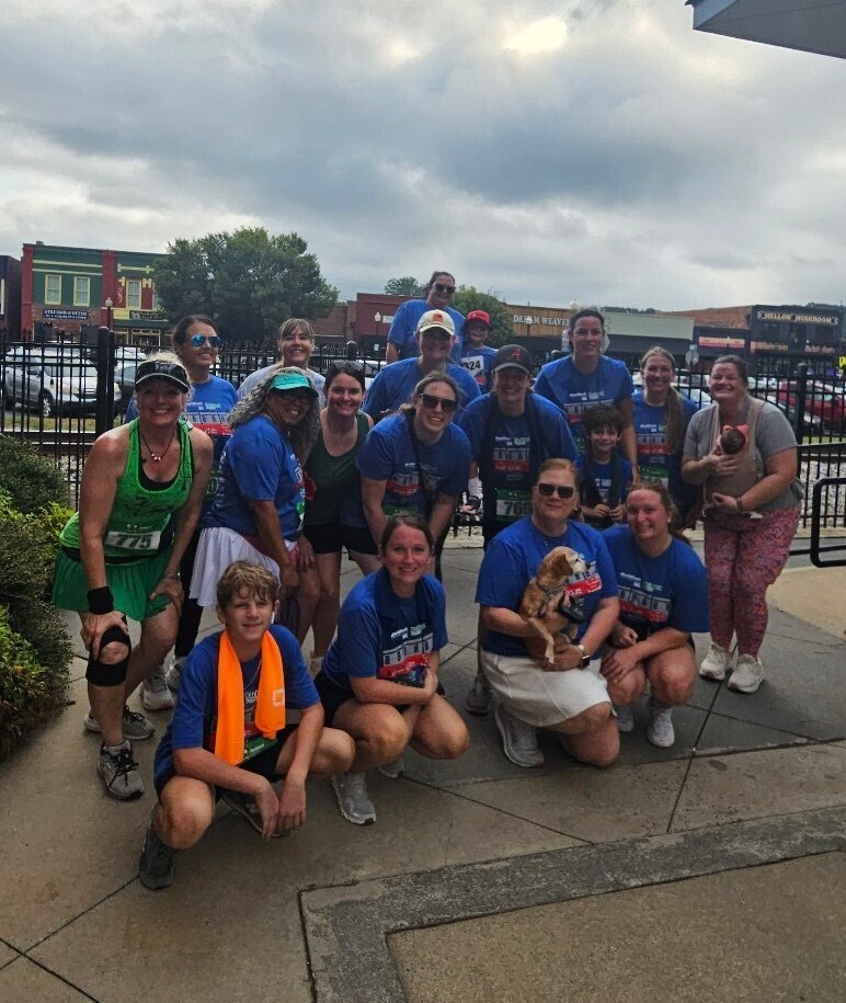Group picture of MRES staff smiling for a picture after the 5K race.
