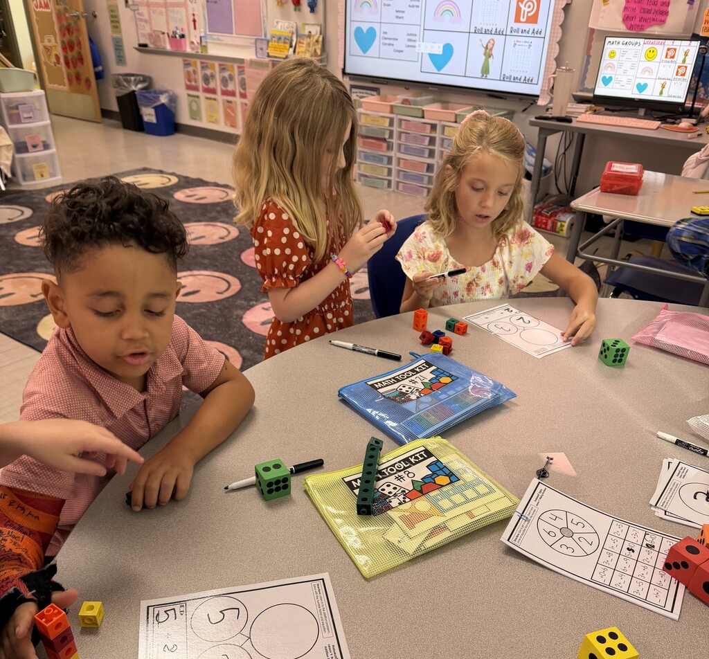 First graders working in a small group on add numbers.