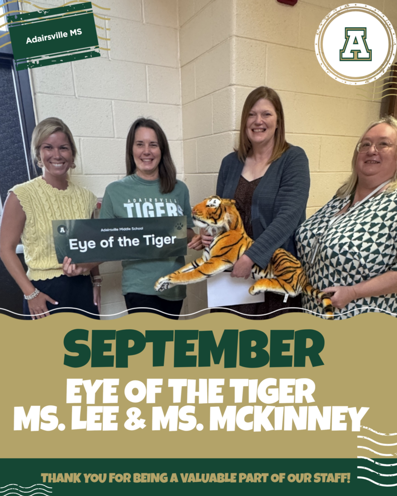 Four women hold a sign and a stuffed tiger. Text reads "September Eye of the Tiger Ms. Lee & Ms. Mckinney."