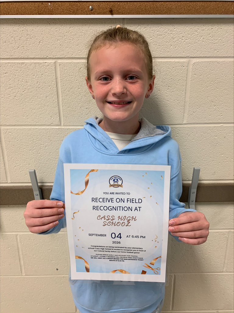 A child holds an award certificate with a blue background. The certificate has a yellow ribbon and the words "Receive on Field Recognition at Cass High School."
