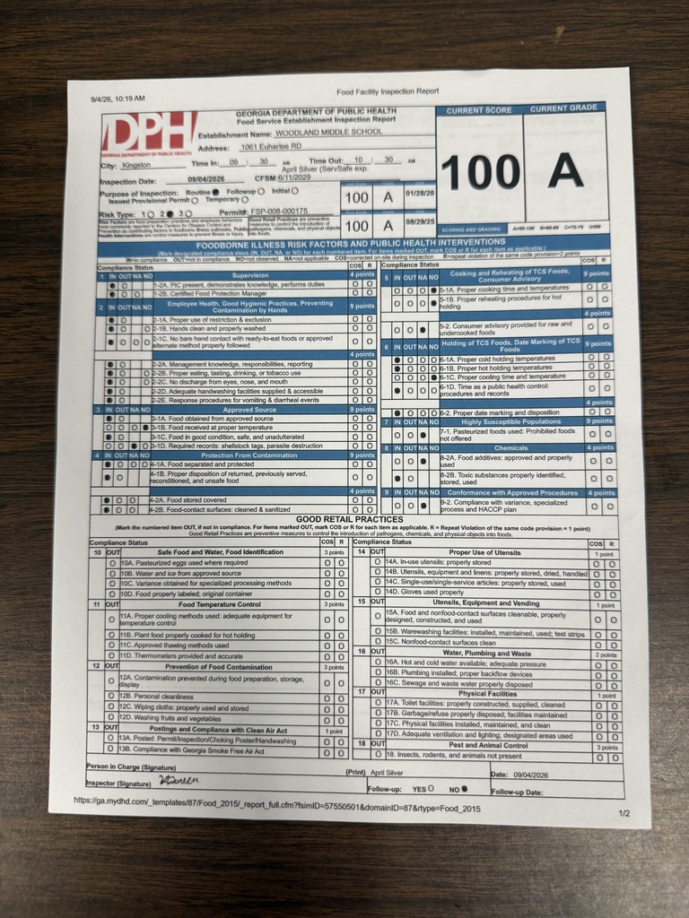 A document labeled "DPH" with the number "100 A" sits on a wooden surface. The document has text and numbers in multiple rows and columns.