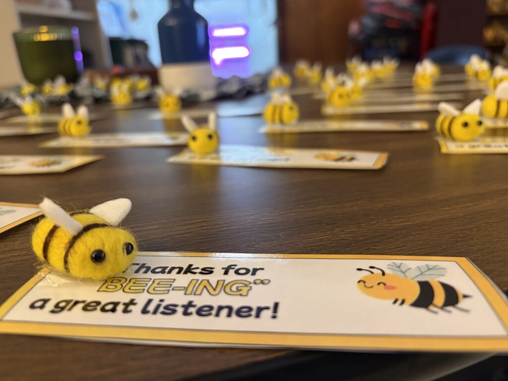 A table with cards, each featuring a bee and a message: "Thanks for BEE-ING a great listener!"