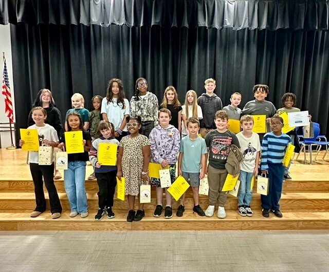 Group picture of spelling bee participants smiling for a picture.