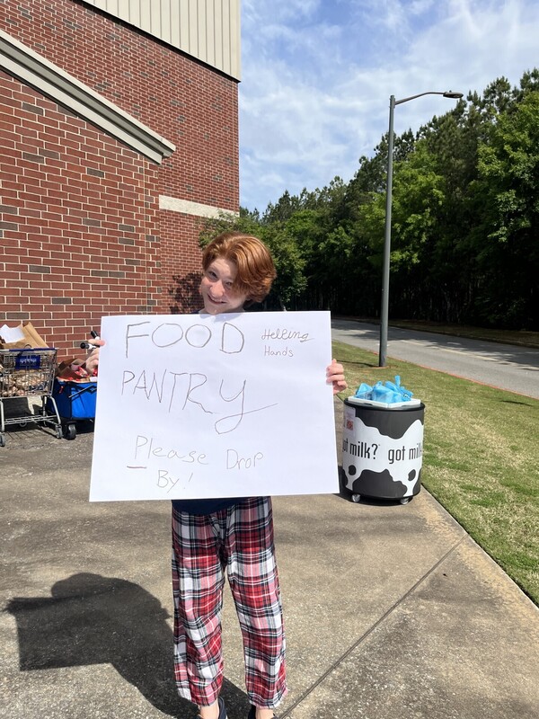 student holding poster