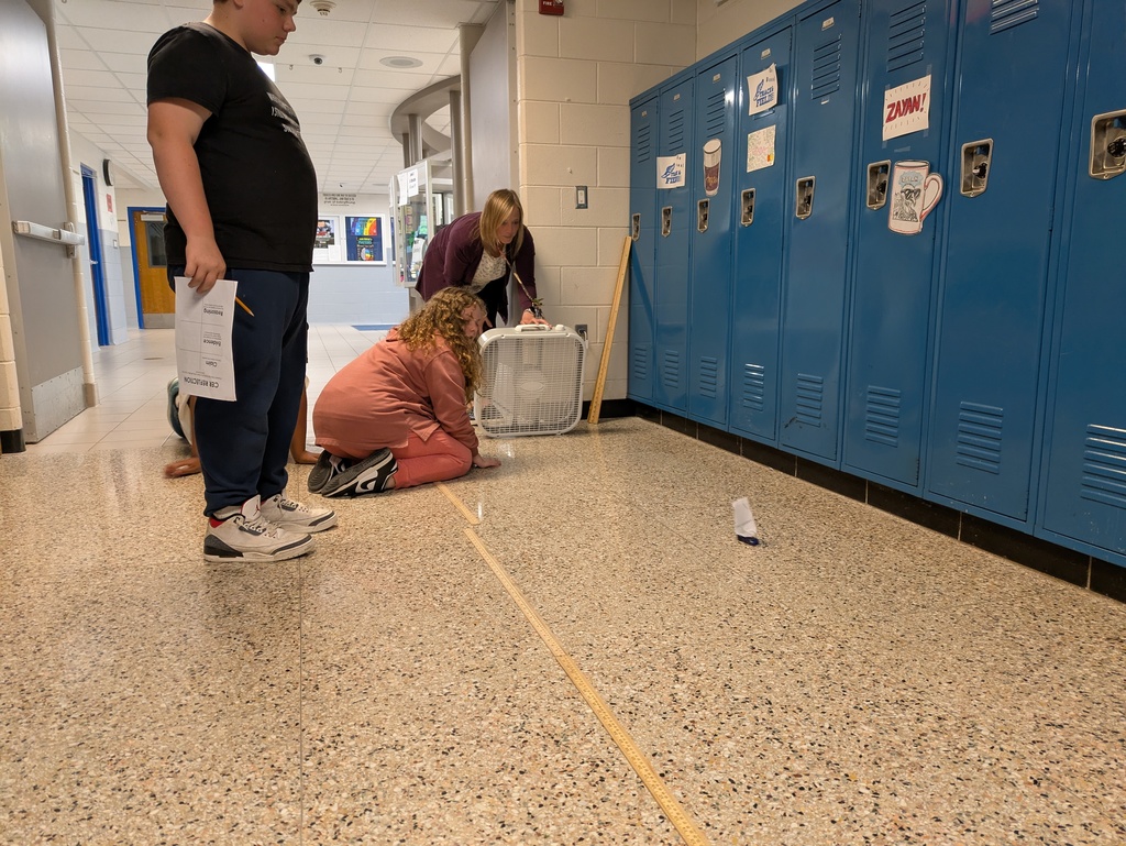 student watching car move down the hallway