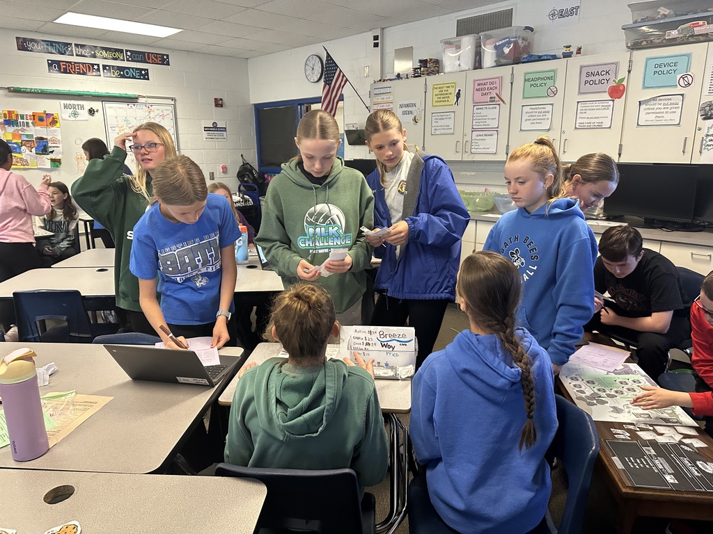A group of students standing around a table