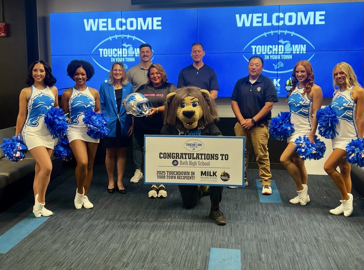 Coach Bismack accepting the check from the Detroit Lions