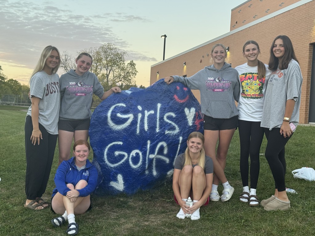 BHS girls golf team next to painted rock