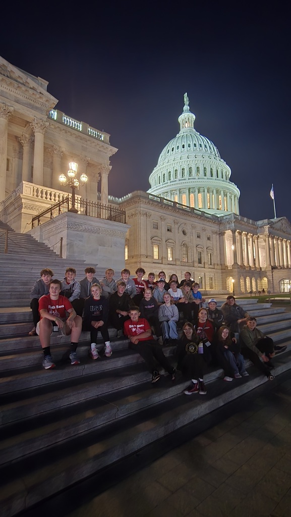 8th graders on sitting on the steps of the Capitol building