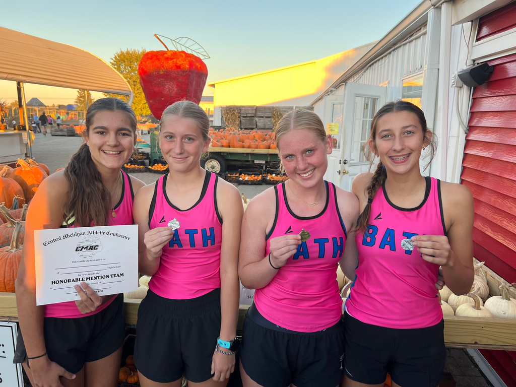 Cross country girls holding their awards