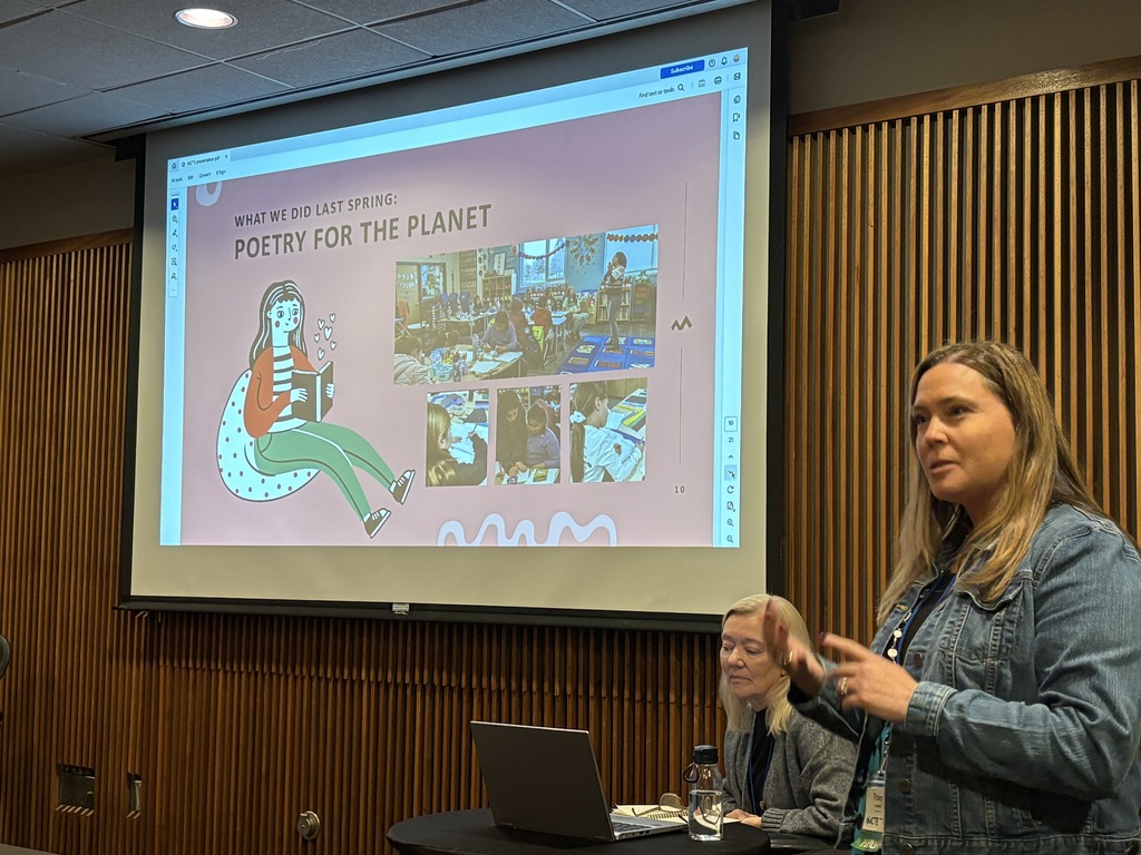 Tracy Grennel standing in front of a screen