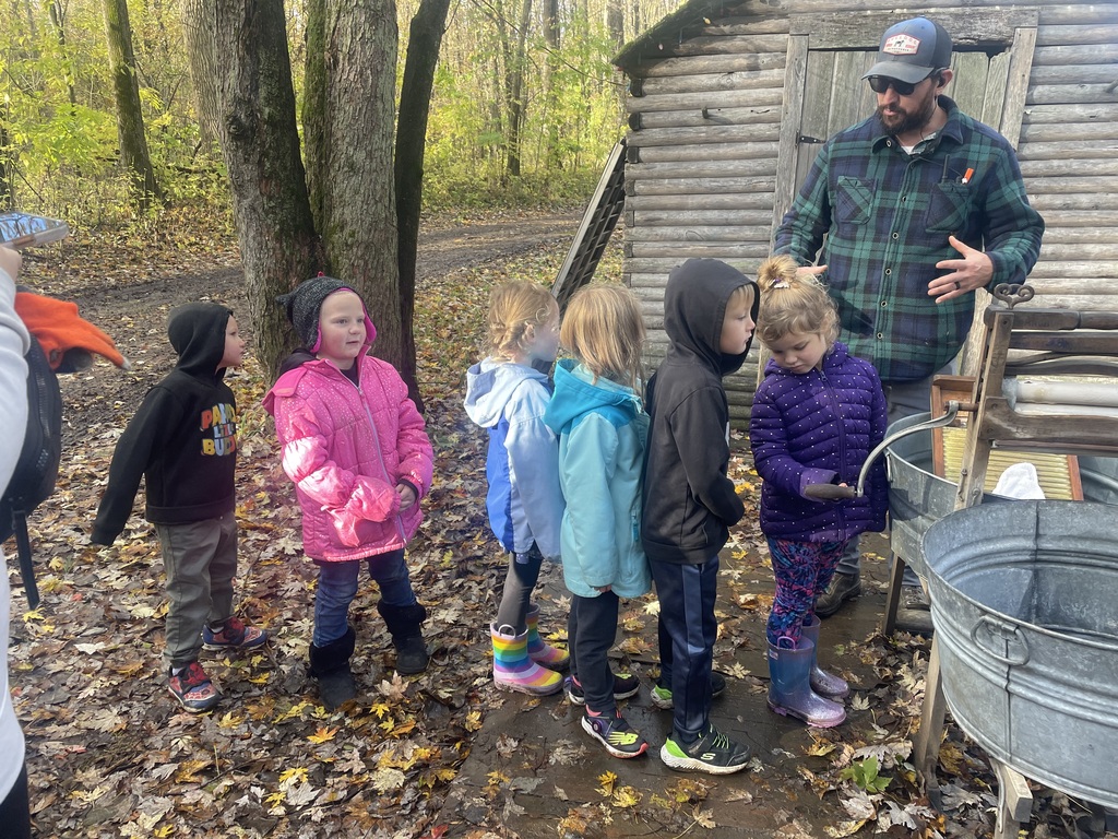 Students washing laundry in tub