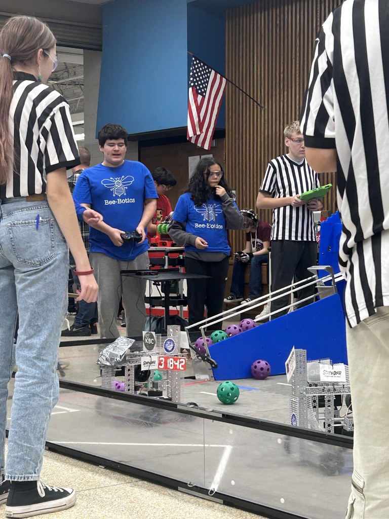 Students watching their robot perform a task