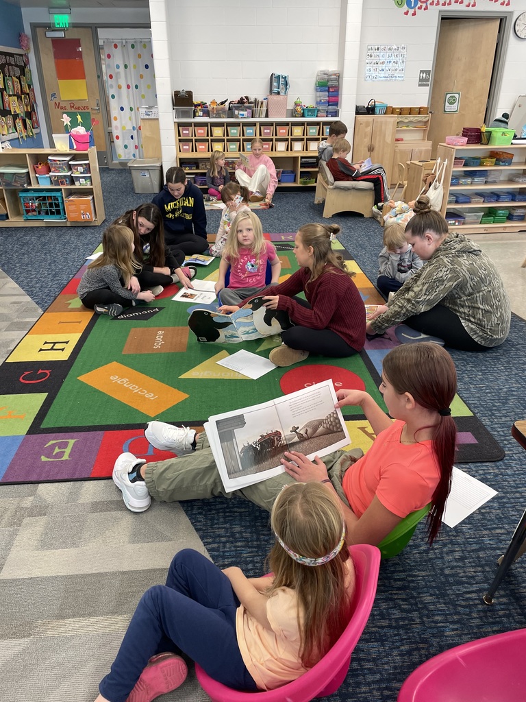 Students sitting on the floor reading books together