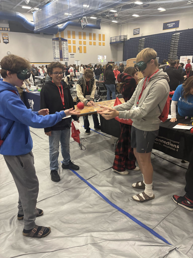 Three boys playing a game.