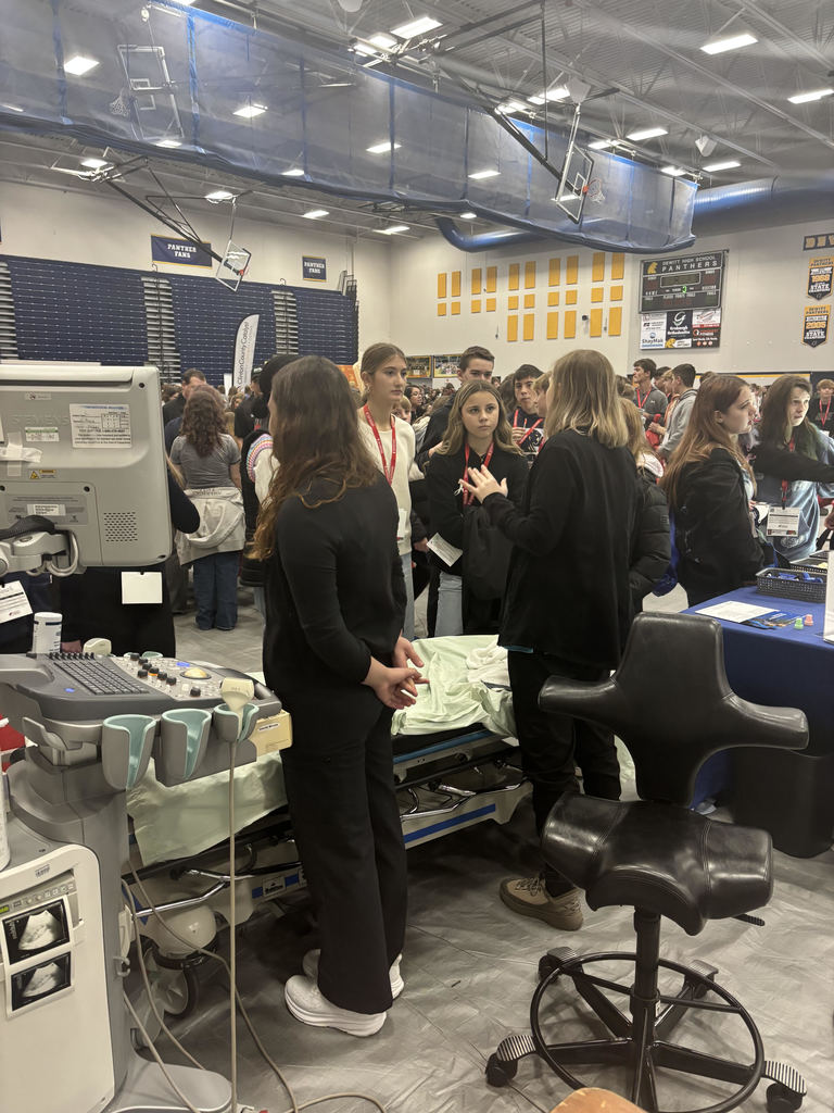 Students talking with health care professionals.