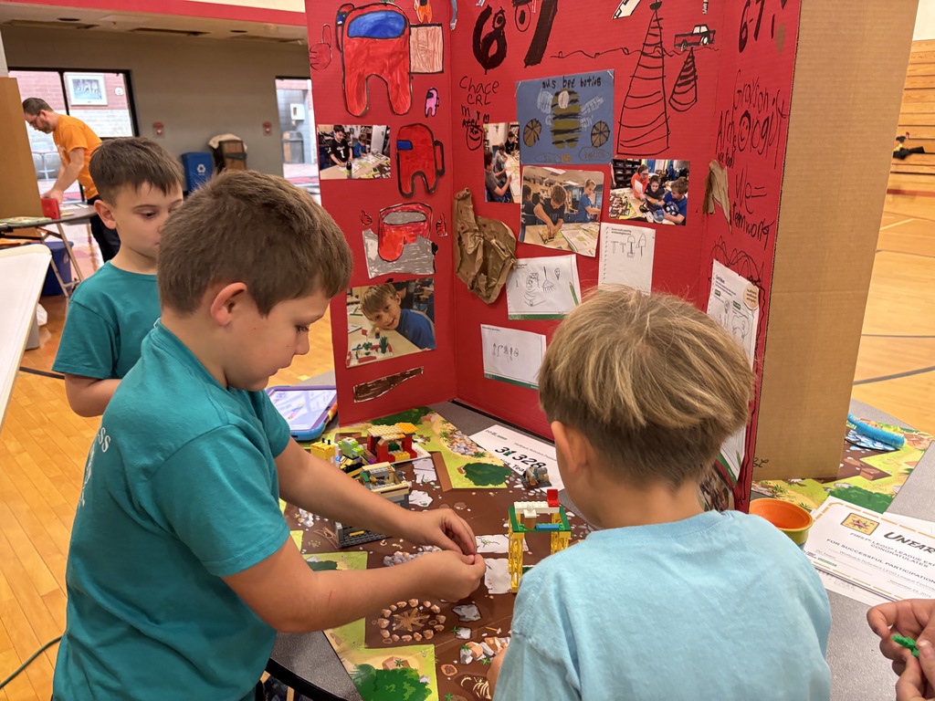 The Bee-Botics team is setting up their project.