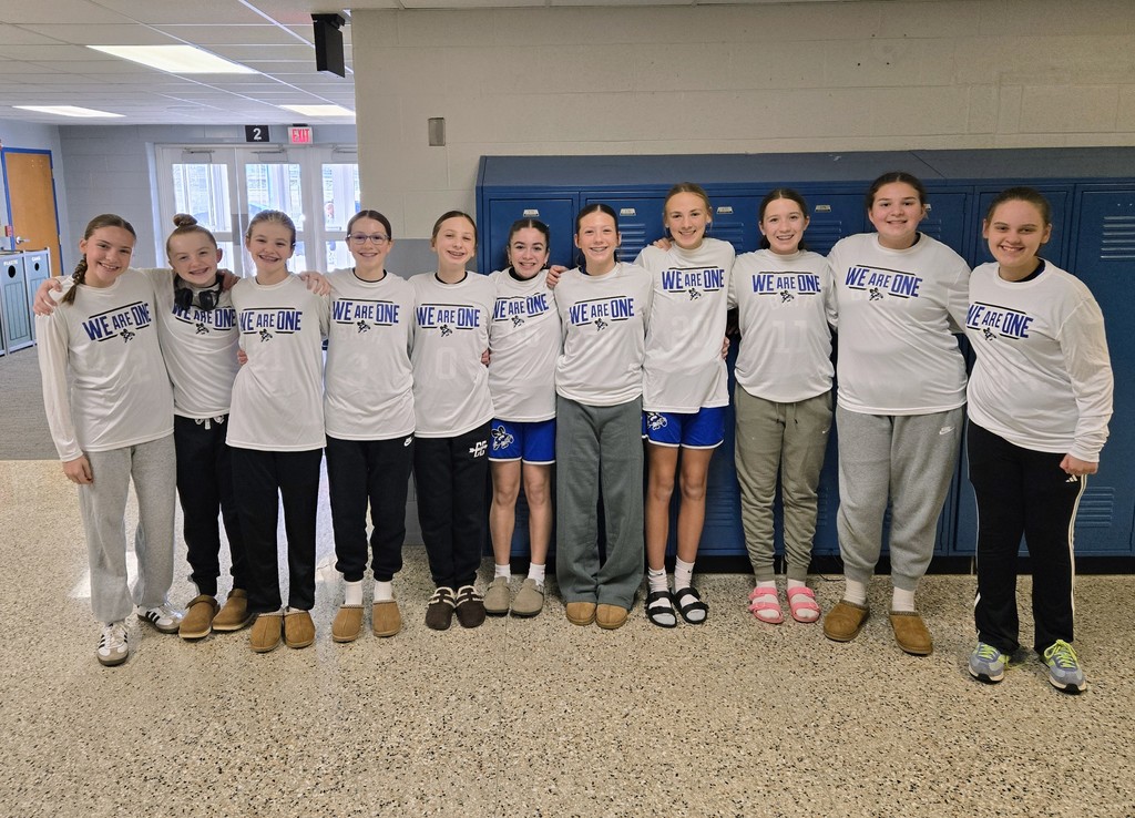 7th grade girls basketball team posing for a photo.